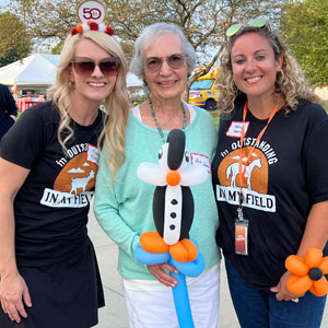 Emily Mays (L) and Ashley Johnson (R), who have planned all of our 50th festivities, shared a moment with Dee Innis, wife of late founder Chuck Innis and mother of Dick Maggiore.